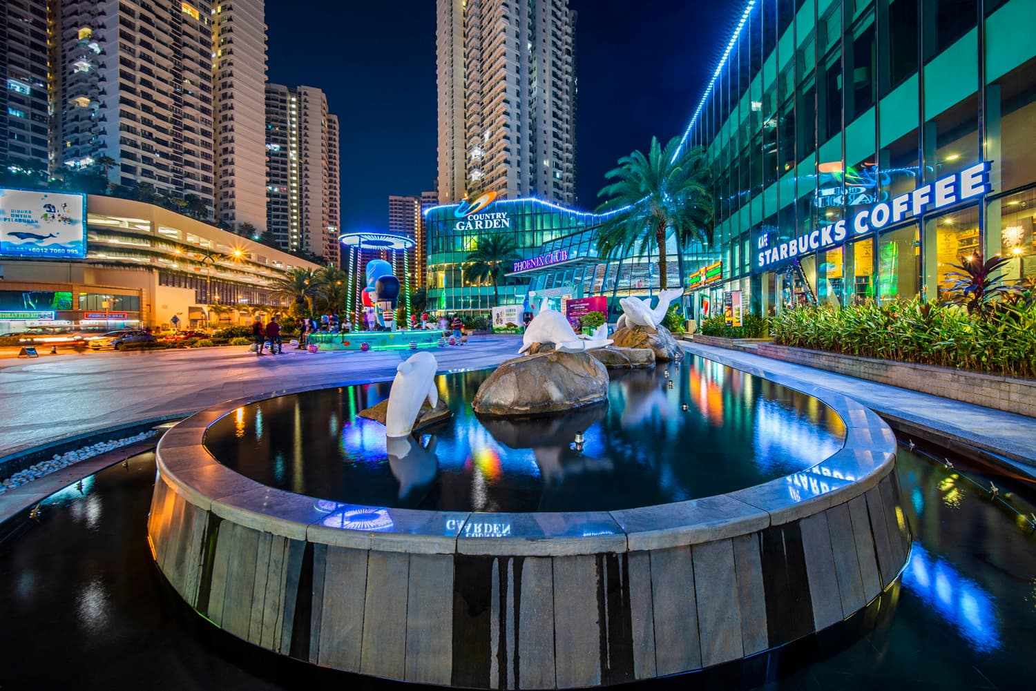 Country Garden Danga Bay Phoenix Club entrance with dolphin fountain and Starbucks at night, Johor Bahru CIQ